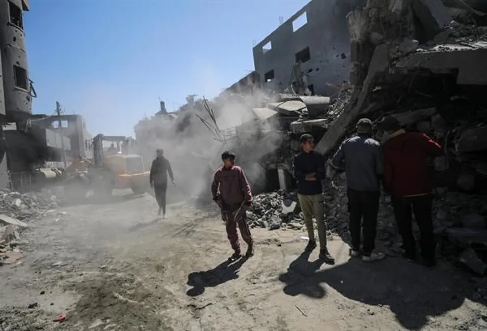 Personas caminan, tras un ataque en la Franja de Gaza, en una fotografía de archivo. Foto: EFE/EPA/Mohammed Saber