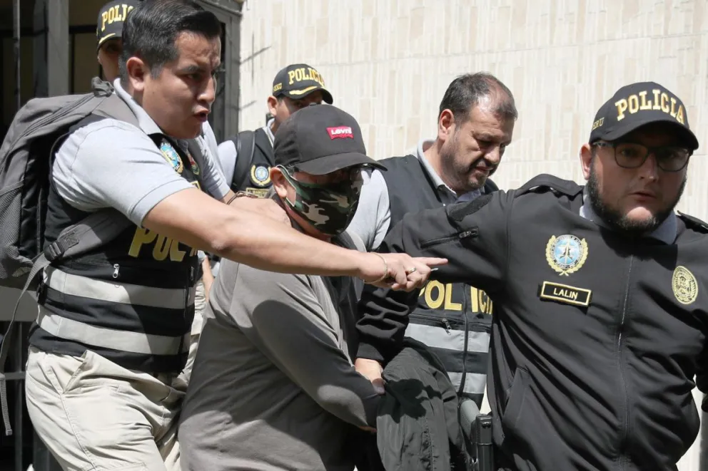 Fotografía que muestra policías mientras trasladan a Nicanor Boluarte (c), hermano de la presidenta de Perú Dina Boluarte. Foto: EFE