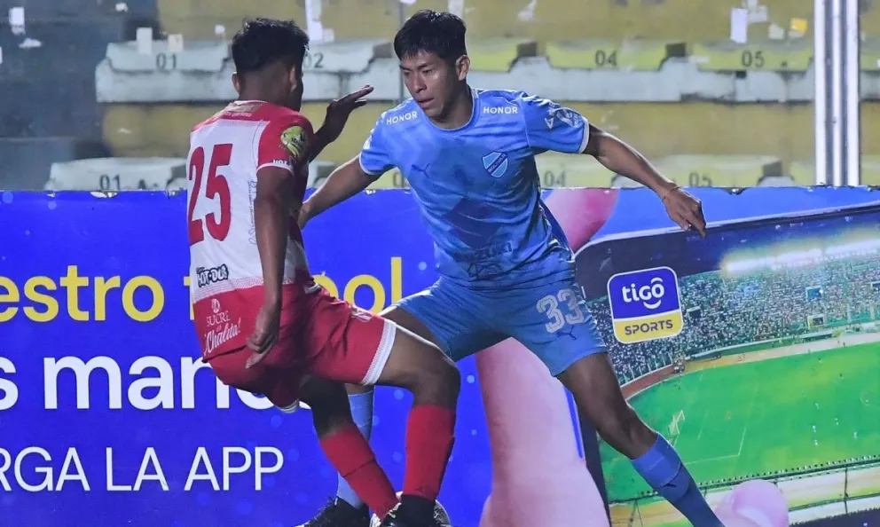 Ervin Vaca (de celeste) trata de superar la marca de un rival de Independiente. Foto: APG.