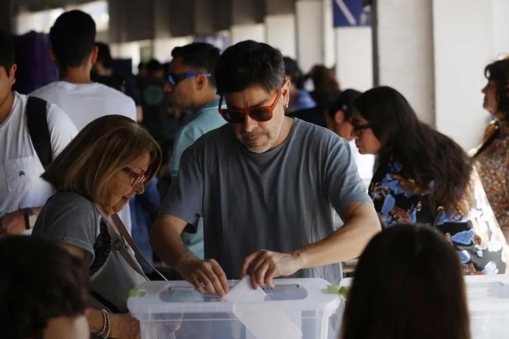 Personas votan en el centro de votación Estadio Nacional durante los comicios electorales municipales, este sábado en Santiago (Chile). Foto: EFE