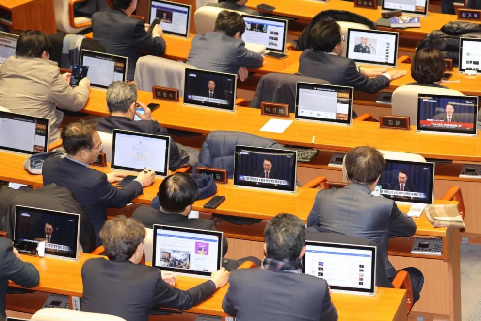Los legisladores de la oposición observan el anuncio televisado del presidente surcoreano, Yoon Suk Yeol. Foto: EFE 