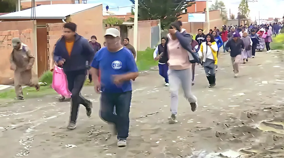 Vecinos corres a sus viviendas tras romper las líneas de seguridad. Foto: Captura 