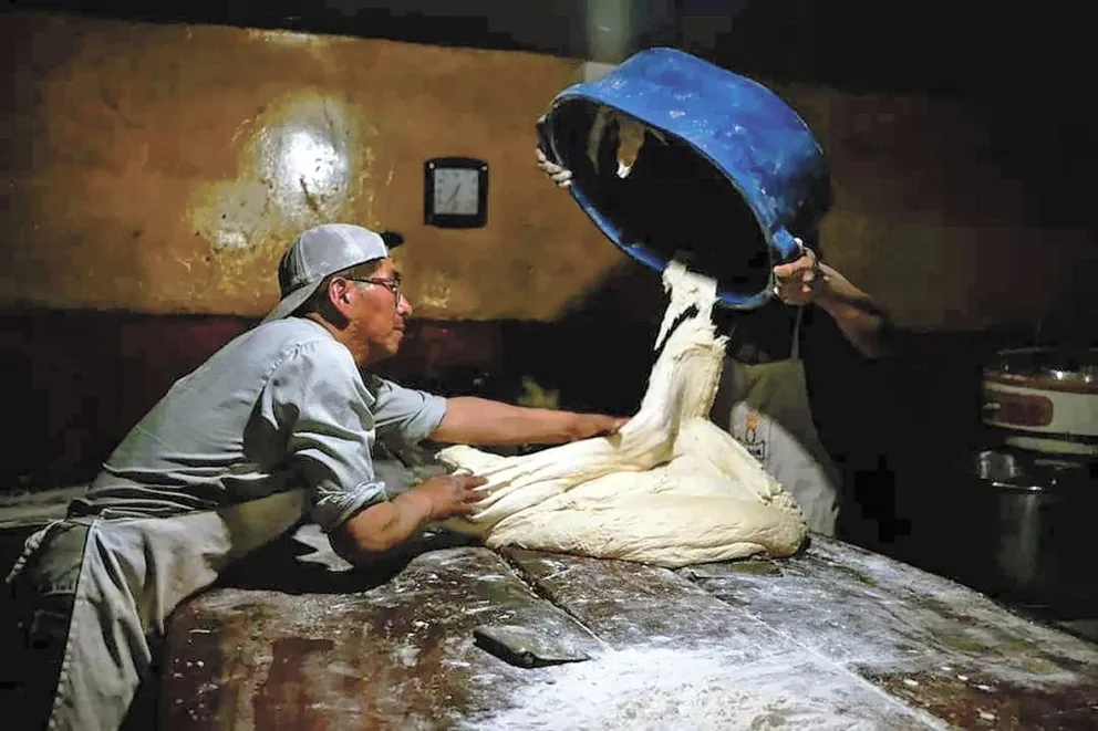 Luis Raimundo Quispe Flores chapea la masa para el pan de batalla en el horno de su casa, en la ciudad de El Alto. Foto: Carlos Sánchez Navas