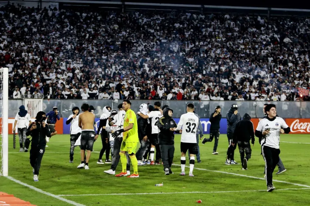 Aficionados de Colo Colo ingresan al campo en el partido contra Fluminense por la Libertadores. Foto: EFE.