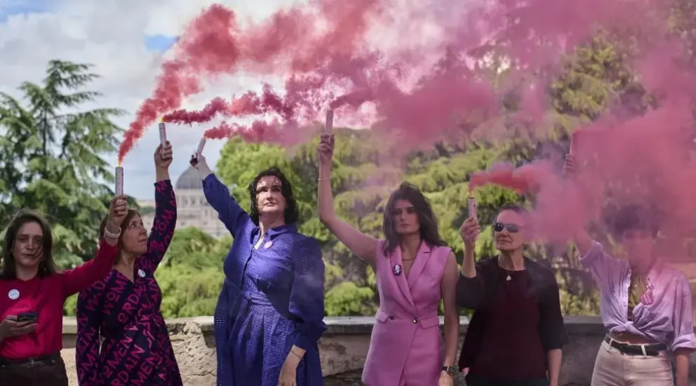 Las mujeres con el humo rosa, este jueves en Roma. Fotos: La Verdad