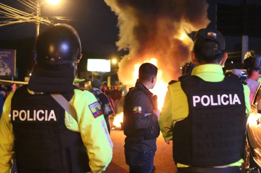 Integrantes de la Policía de Ecuador en la madrugada de este martes, 16 de agosto, al vigilar una carretera bloqueada, durante una manifestación por la reciente alza del precio del diésel, en el Carchi (Ecuador). Foto: EFE