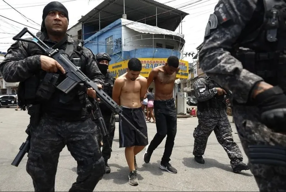 Policías de Río de Janeiro trasladan a un grupo de personas durante un operativo, el 28 de octubre. Foto: EFE