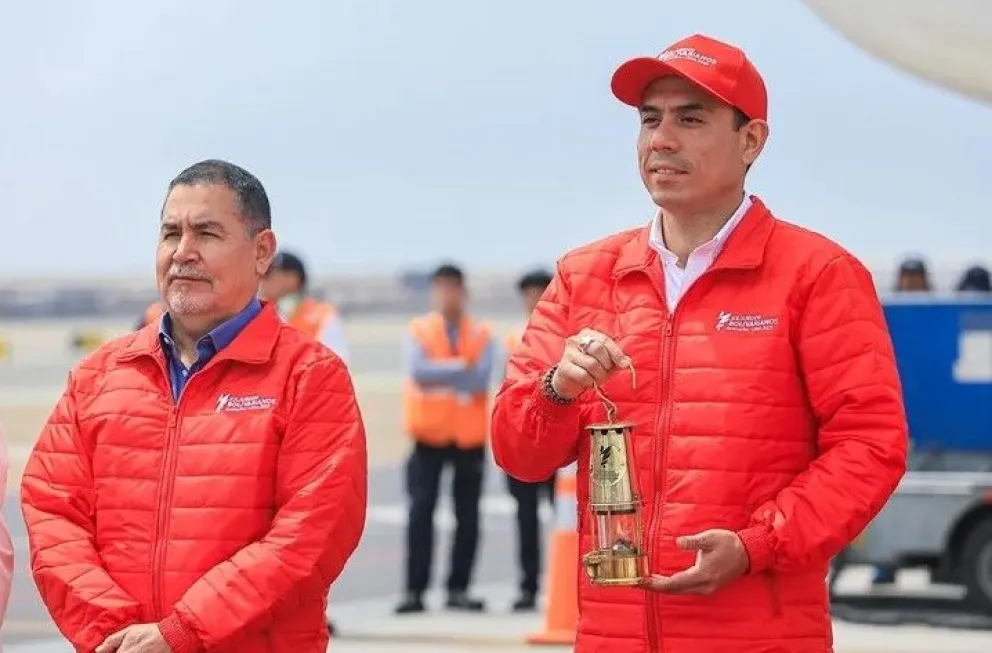 José Jerí, el residente de Perú, sostiene el recipiente de vidrio que porta la "llama bolivariana". Foto: EFE