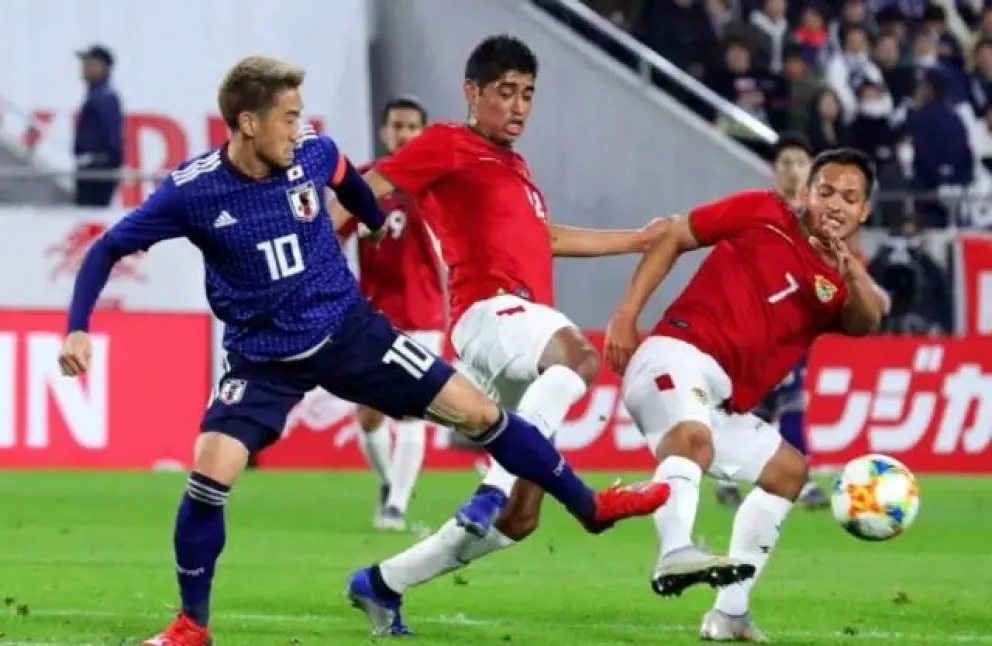 Jhasmani Campos y Raúl castro pelean el control del balón con un rival de Japón en el partido de 2019. Foto: HFB