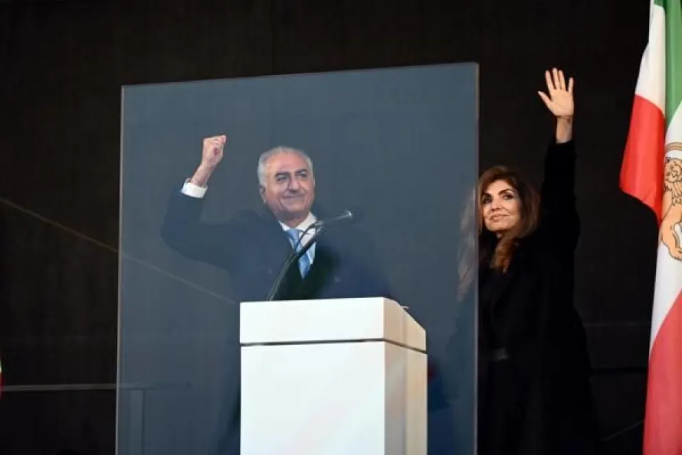 El príncipe heredero iraní Reza Pahlavi (L) y su esposa Yasmine Pahlavi (R) hacen gestos a los simpatizantes durante una concentración para denunciar la represión del gobierno iraní a las recientes protestas. EFE