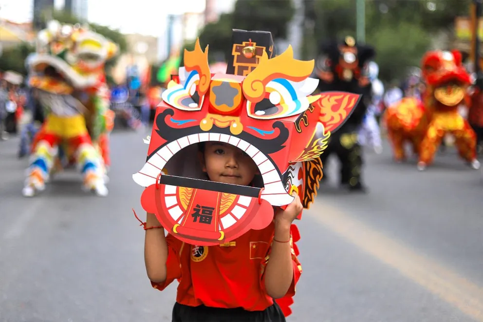 Una niña viste una máscara de león chino durante un desfile por el Año Nuevo Chino este sábado, en La Paz (Bolivia). Foto: EFE