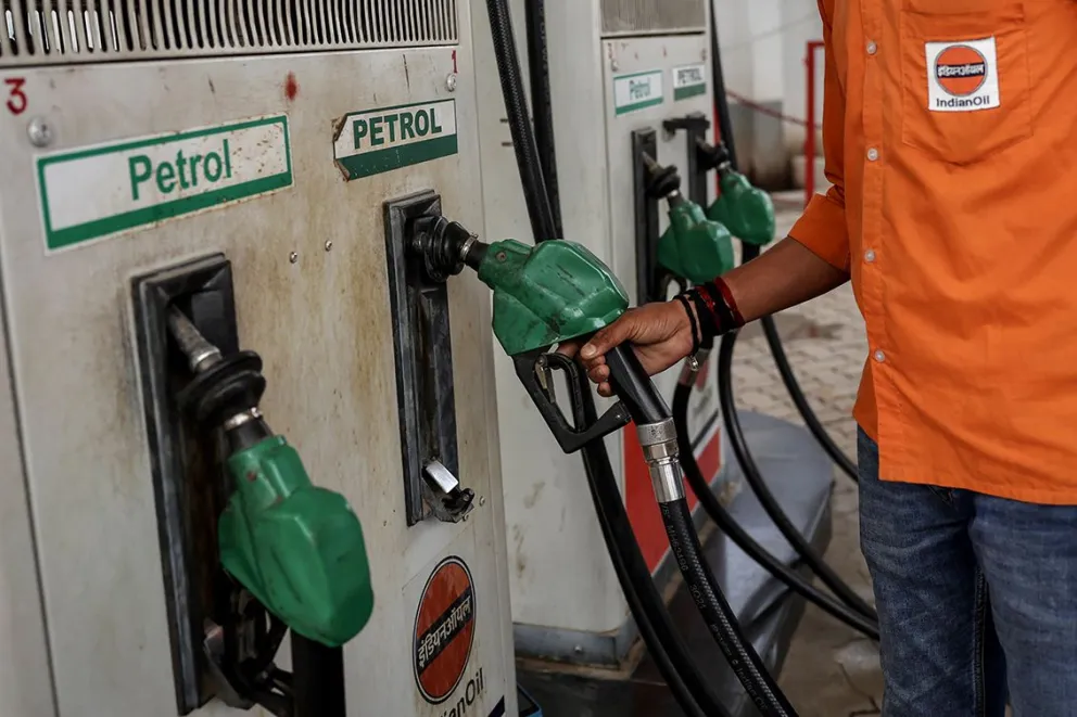 Un empleado de una gasolinera toma una boquilla para repostar un vehículo en una gasolinera de Indian Oil en Varanasi el 10 de marzo de 2026. Foto: AFP