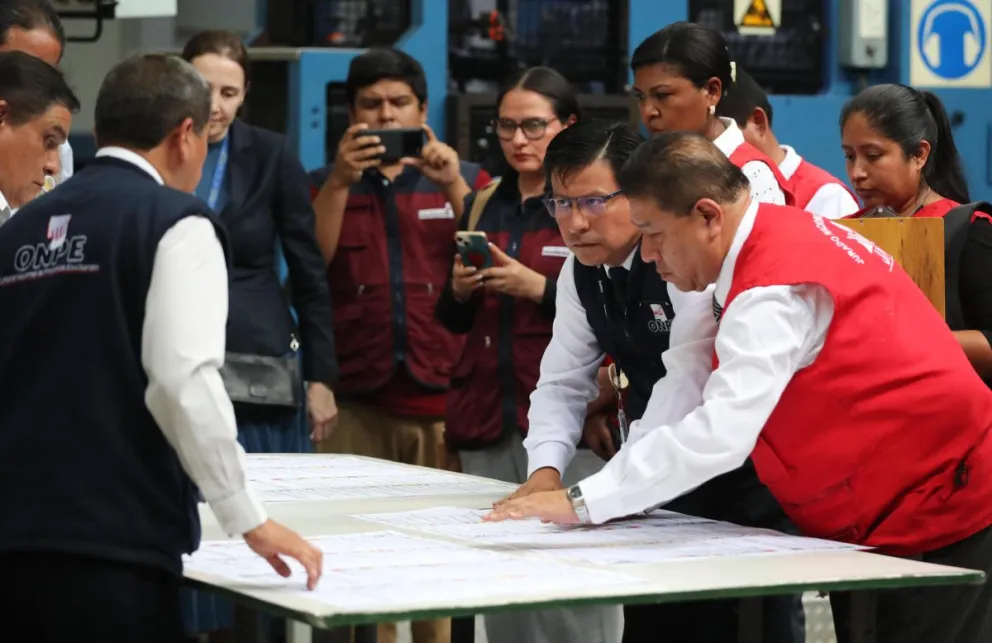 Personas observan una prueba de la papeleta de votación este 10 de marzo de 2026, en la Oficina Nacional de Procesos Electorales (ONPE) en Lima (Perú). Foto: EFE