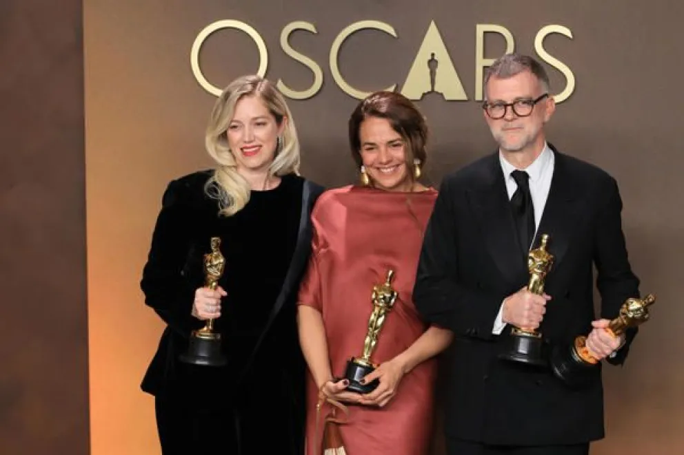 Sara Murphy (i) Paul Thomas Anderson (d) posan con la estatuilla a mejor película por 'One Battle After Another' junto a Carmen Ruiz de Huidobro . Foto: EFE