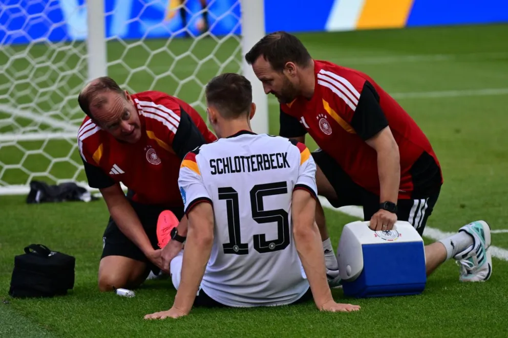 El internacional alemán Nico Schlotterbeck recibe atención médica tras lesionarse durante el partido ante Costa de Marfil. Foto: EFE