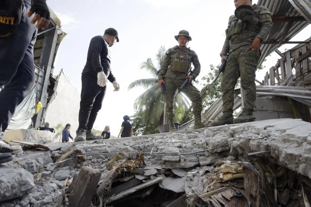 Soldados del Ejército de Filipinas inspeccionan los daños en el lugar donde se derrumbó un muro. Foto: EFE 