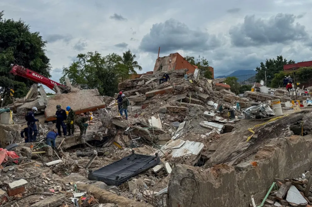 Rescatistas realizan este domingo labores de búsqueda en los escombros del edificio Torres del Limonar, destruido por el terremoto del pasado lunes, en Cali (Colombia). EFE/ Mario Baos