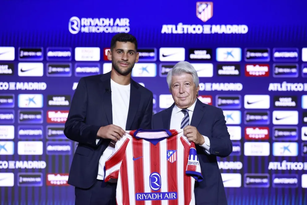 El argentino Cristian "Cuti" Romero (izq.) posa junto al presidente del club, Enrique Cerezo (d), durante su presentación. Foto: EFE