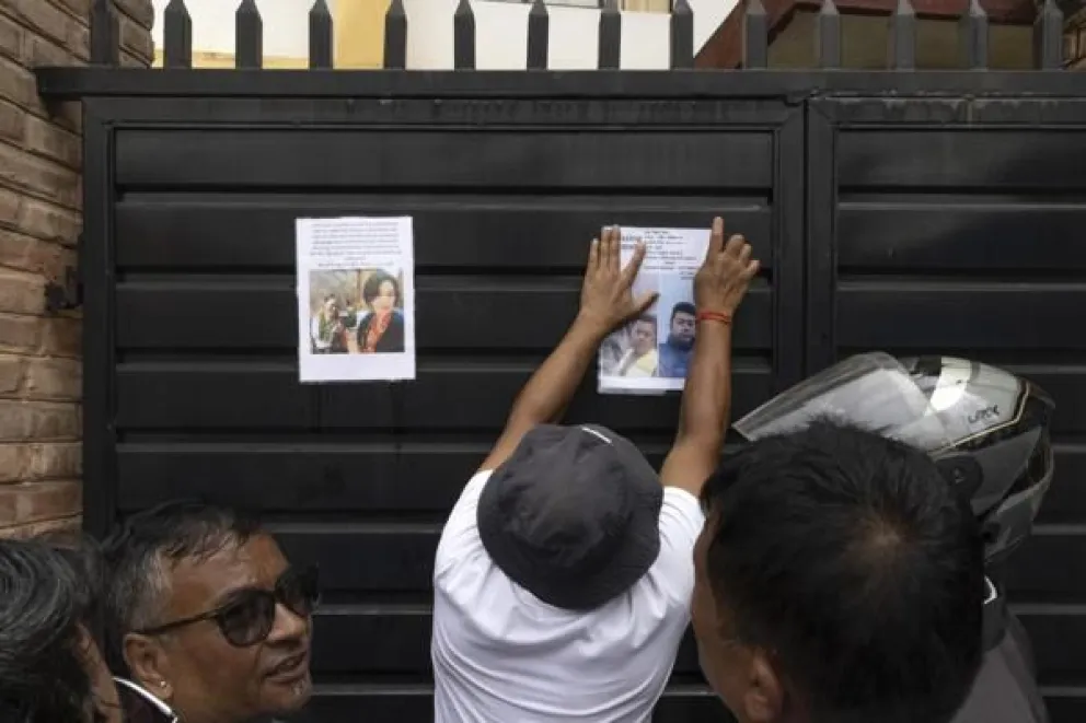 Kathmandu (Nepal), 29/08/2026.- Personas pegan fotos de desaparecidos en la riada de Nepal. Foto EFE
