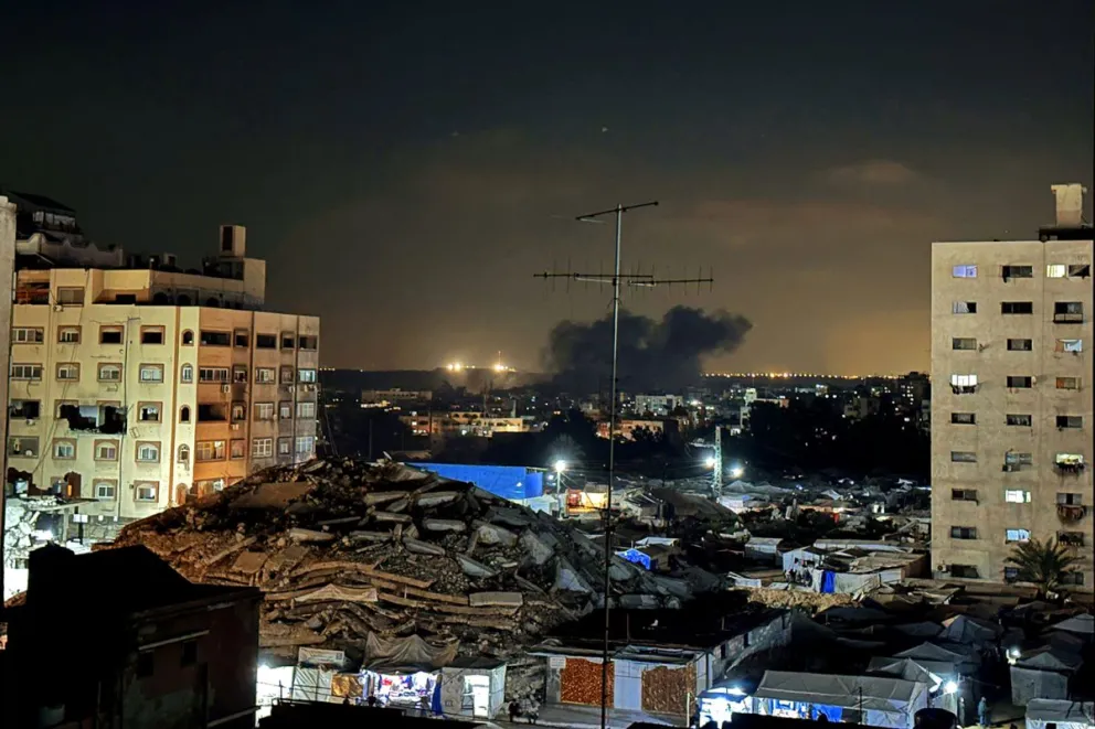 La fotografía muestra el horizonte nocturno con una columna de humo en la Ciudad de Gaza. Foto: EFE