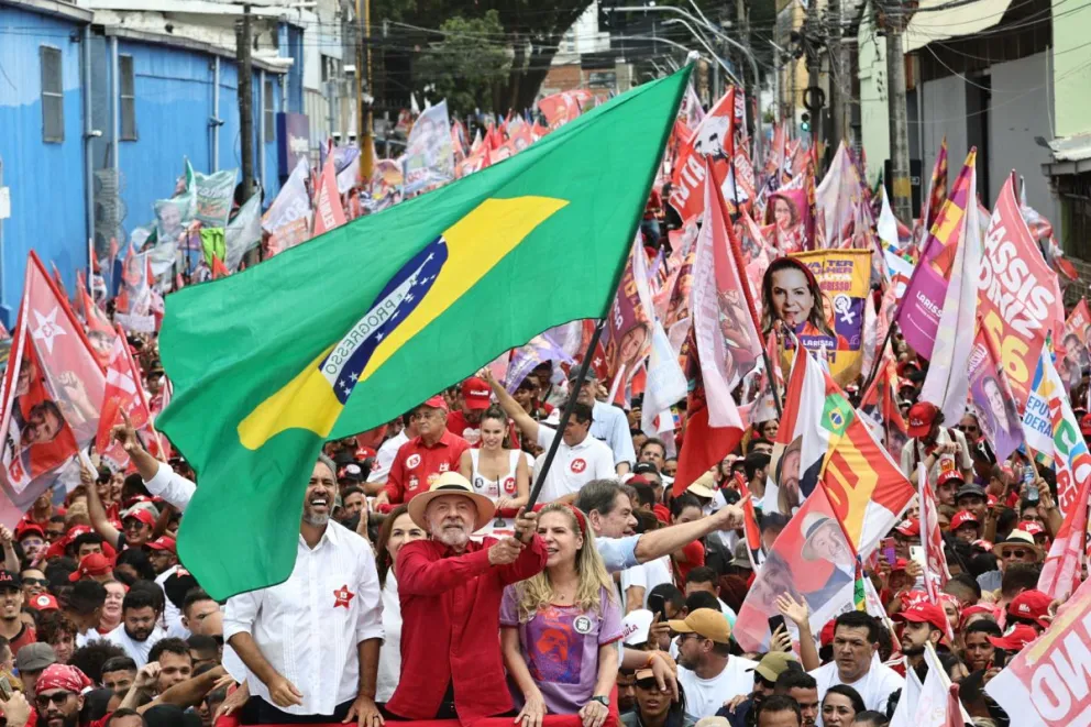 El presidente de Brasil y candidato a la reelección, Luiz Inácio Lula da Silva (c-i), fue captado este 29 de septiembre al sostener en alto la bandera de su país, durante un acto de campaña, en Fortaleza (Brasil). Foto: EFE